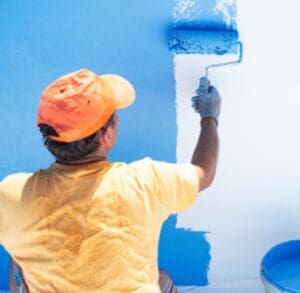 Painter man at work with a paint roller