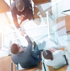 Handshake,Across,The,Table.,Meeting,Around,A,Boardroom,Table.