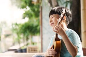 An,Adorable,And,Smart,Asian,Little,Boy,Happy,Playing,Song