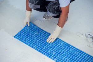 Worker,Laying,Tile,In,The,Pool.,Pool,Repairing,Work.