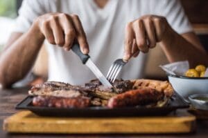 Man,Eating,Grilled,Meats
