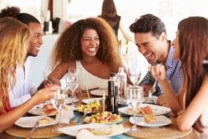 Group,Of,Young,Friends,Enjoying,Meal,In,Outdoor,Restaurant