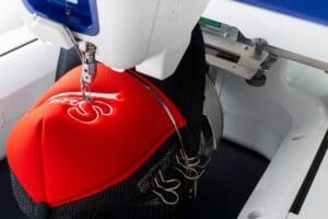 Working,White,Embroidery,Machine,Embroidering,Logo,On,Red,And,Black