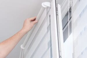 Man,Hands,Installing,Window,Roller,Duo,System,Day,And,Night.