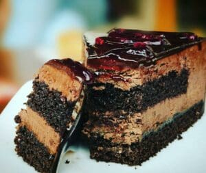 4674823610Chocolate cake with raspberry sauce Cut in two pieces