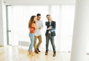 Young,Happy,Couple,And,An,Agent,In,A,New,Property