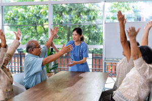 At home care service nurse caregiver take the lead to elderly person exercise in every morning