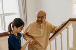 Nurse helping the elderly walk up the stairs