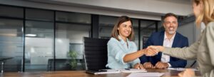 Latin,Business,Team,Of,Woman,And,European,Man,Shaking,Hands