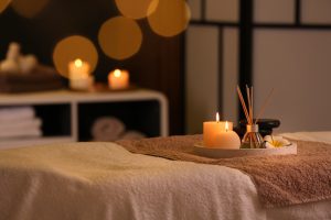 Burning,Candles,And,Aromatic,Reed,Freshener,On,Table,In,Spa