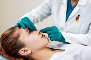 Clinique FaceMD lady with plaster nose doctor examining patients face after plastic surgery