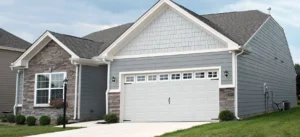 Home Guys house with garage and shake siding left photo
